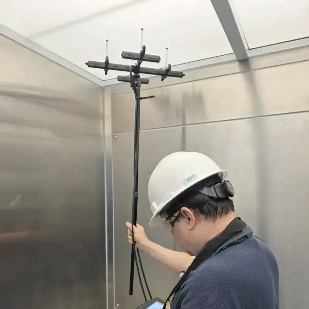 Technician taking airflow readings with a multi-probe rig
